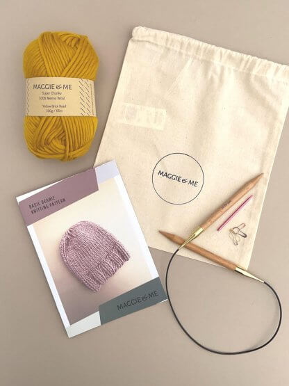 A Basic Beanie Knitting Kit with yarn and knitting needles.